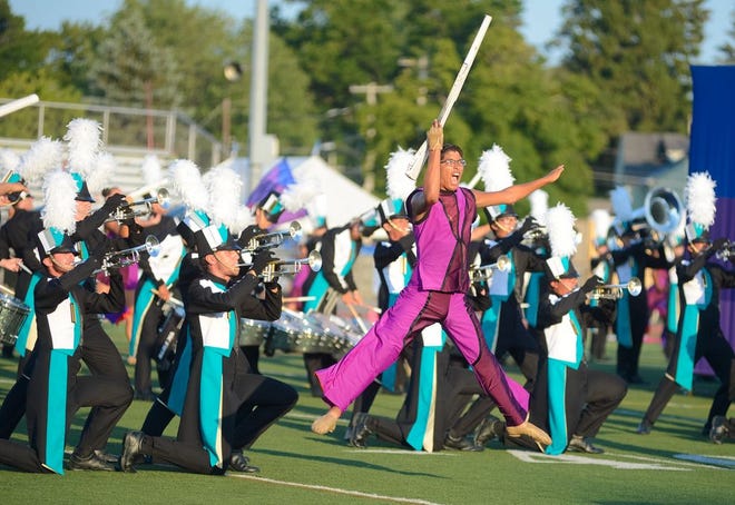 Lindsay A. Mogle / Observer-Dispatch  A Pacific Crest Drum and Bugle Corps colorguard member performs a rifle feature during their show entitled, "The Catalyst" at the Drums Along the Mohawk competition at RFA Stadium on Wendesday, July 29, 2015.
