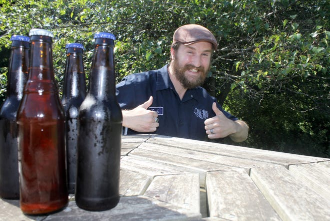 Zack Bigelow, founder of Ramshackle Brewing Company, gives two thumbs up to his brews. Bigelow and his wife, Jessy, along with Joe Kesselring, make some 20 different brews. ANDY BARRAND PHOTO