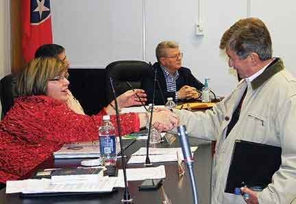 Anderson County Commissioner Robin Biloski, left, shakes hands with long-time state legislator Randy McNally of Oak Ridge prior to a December 2011 County Commission meeting at the Courthouse in Clinton.