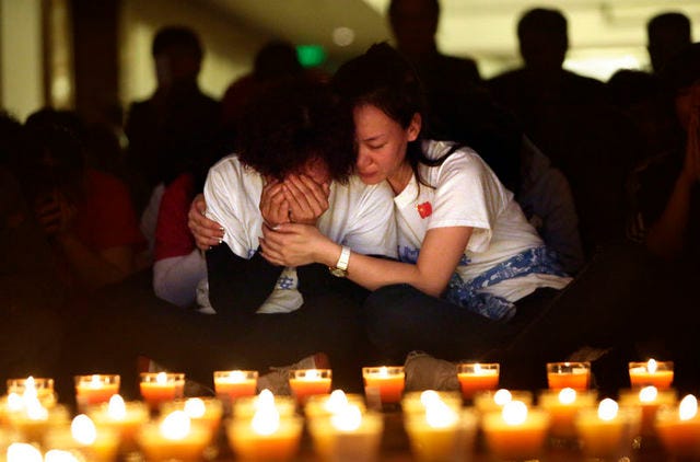 A family member cries as she and other relatives pray in April 2014 during a candlelight vigil at Lido Hotel in Beijing for passengers aboard the missing Malaysia Airlines Flight MH370. (REUTERS/Jason Lee)