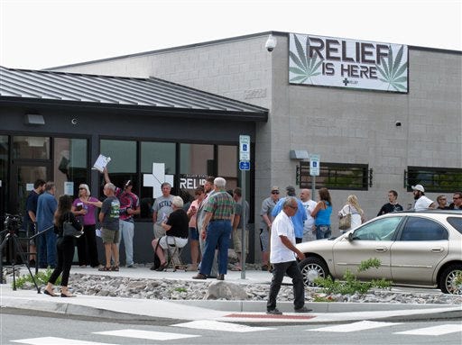 Dozens of people line up outside the Silver State Relief medical marijuana dispensary in Sparks, Nev., Friday, July 31, 2015, to be among the first in Nevada to legally purchase medicinal pot. Nevadans voted to legalize medical marijuana in 2000, but no language was in place to establish a system to sell or distribute it until 2013. (AP Photo/Scott Sonner)