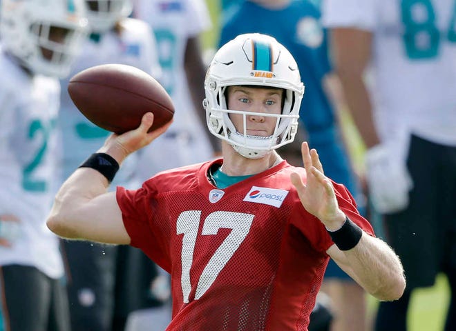 In this Thursday, July 30, 2015 photo, Miami Dolphins quarterback Ryan Tannehill throws a pass at the teams NFL football training camp, in Davie, Fla. (AP Photo/Wilfredo Lee)