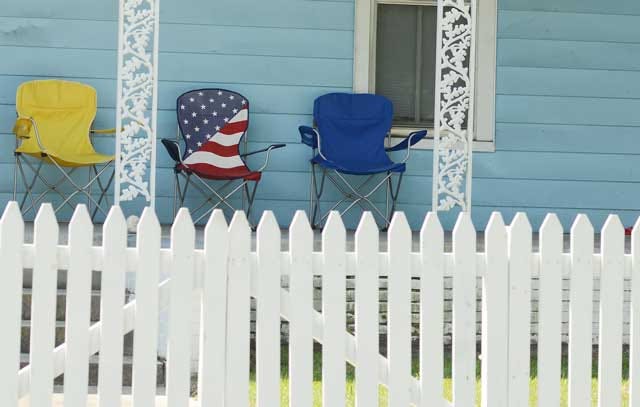 Three brightly colored chairs standout against the soft blue paint on a house on the 400 block of Blount Street on Friday. Brightly colored houses and picket fences are part of the ongoing transition of Mitchelltown and Kinston’s artistic impact.