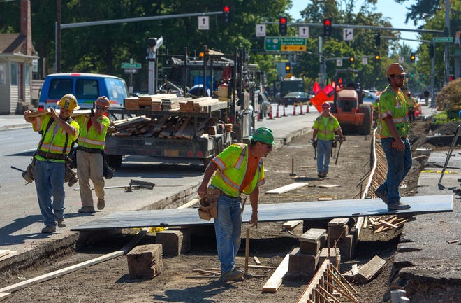 Work continues on Lane Transit District’s west Eugene extension of the EmX line on Seventh Avenue at Madison Street. (Brian Davies/The Register-Guard)