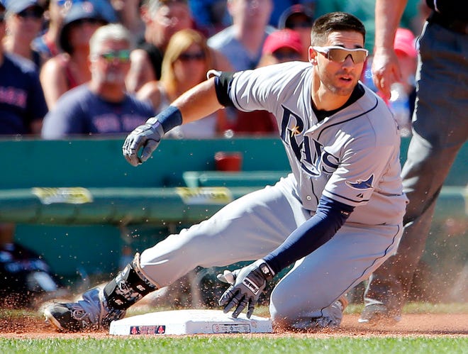 Tampa Bay Rays' Kevin Kiermaier slides into third base with a triple against the Boston Red Sox during the seventh inning of a baseball game at Fenway Park in Boston, Sunday, Aug. 2, 2015.