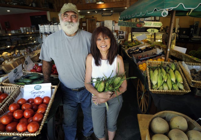 Edmond and Toni Paquette stand at their Paquette Farm stand on Route 140 in Shrewsbury, which has both a retail and wholesale business selling produce to local supermarkets and restaurants. T&G Staff/Christine Peterson