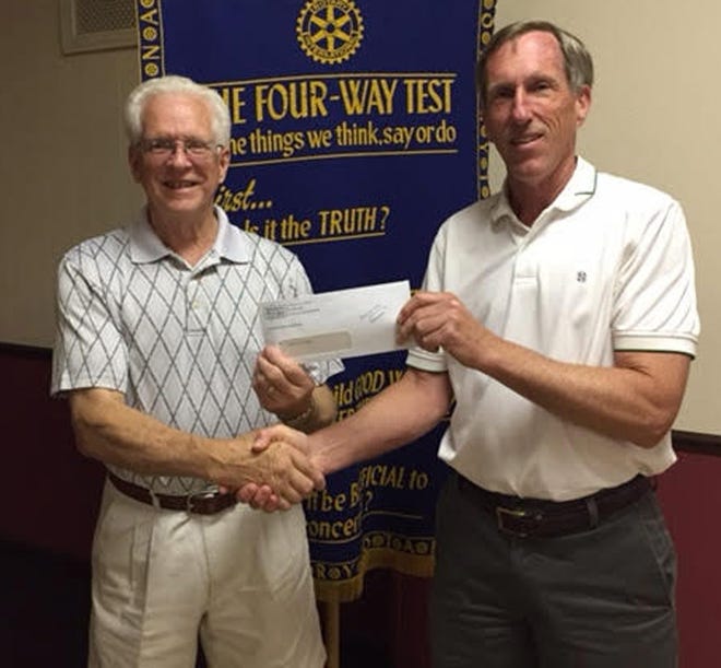 Tom Kramer hands a check to Pat Straw for the Branch Area Food Pantry. Courtesy Photo