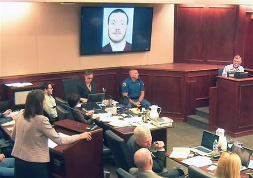 In this July 28, 2015, file image, made from Colorado Judicial Department video, defense attorney Tamara Brady, left, questions Robert Holmes, top right, the father of James Holmes, background left, during the sentencing phase of the Colorado theater shooting trial in Centennial, Colo.