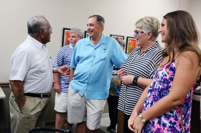 Doug Wiley (center), Sandra Wiley, and Sarah Wiley visit with Phil Caudillo, who spent 31 years with the Wiley Department Store, during their visit to the Wiley Plaza on Saturday, August 1, 2015. Members of the Wiley family were on hand to tour the building as well as visit with alumni of the department store.