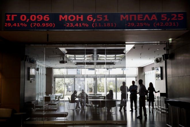 GREECE'S MAIN STOCK INDEX  plunged more than 22 percent as it reopened Monday for the first time in five weeks. The markets and banks were closed June 29 to keep a run on the banks from bringing down the financial system.
