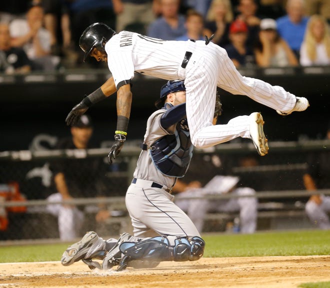 Tampa Bay Rays catcher Curt Casali tags out Chicago White Sox's Alexei Ramirez at home on a throw from center fielder Kevin Kiermaier, during the ninth inning of a baseball game Monday, Aug. 3, 2015, in Chicago. The Rays won 5-4. (AP Photo/Charles Rex Arbogast)