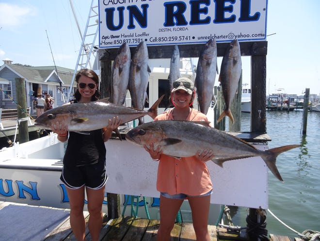 Keaira Musgrove and Savannah Steele of Louisiana show off a pair of amberjack they caught Monday aboard the Un Reel with Capt. Paul Dale Wagner.