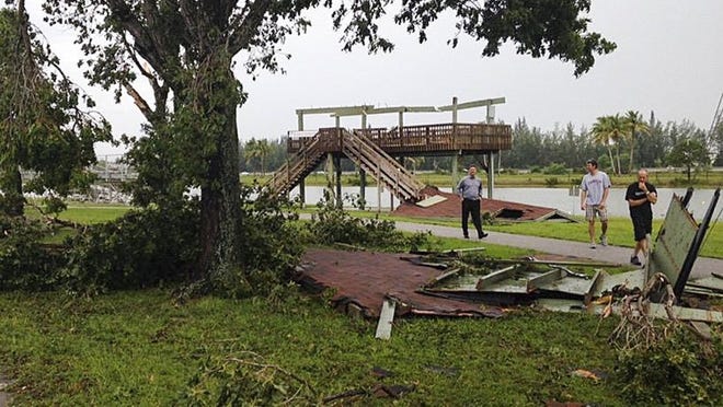 People look parts of the roof from a deck used as a judges stand during water ski events at Okeeheelee Park. The National Weather Service confirmed that a tornado came through the park, August 3, 2015. ((Andrew Ruiz/WPTV News Channel 5)