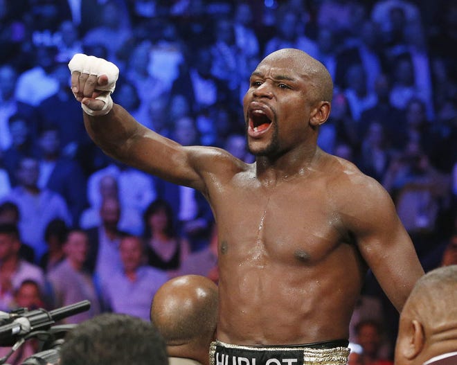 In this May 2, 2015, file photo, boxer Floyd Mayweather Jr., celebrates his unanimous decision victory over Manny Pacquiao, from the Philippines, after their welterweight title fight in Las Vegas. Mayweather Jr. will return to the ring for the first time since boxing's richest fight ever, facing Andre Berto on Sept. 12 in Las Vegas. (AP Photo/John Locher, File) Floyd Mayweather Jr., Manny Pacquiao
John Locher