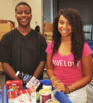 Jaquavyis Gordon and Winter Spikes from Brothers and Sisters Doing the Right Thing help sort food at All Faiths Food Bank.
COURTESY PHOTO