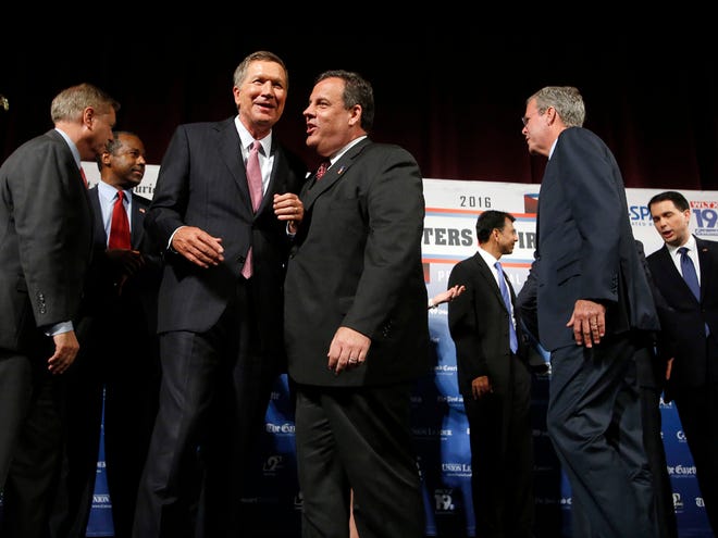 Republican presidential candidates, from left, Lindsey Graham, Ben Carson, John Kasich, Chris Christie, Bobby Jindal, Jeb Bush and Scott Walker speak among themselves after a forum Monday in Manchester, N.H.