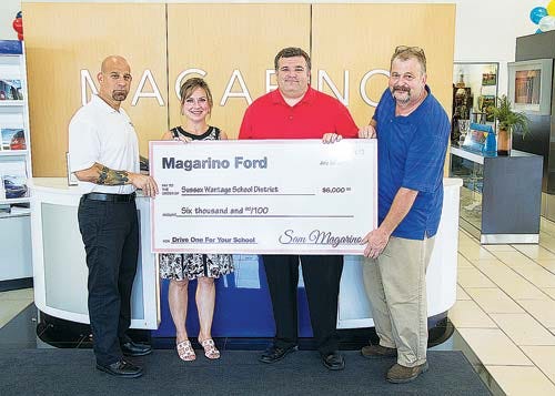 Submitted photo — From left, Sam Magarino Jr., general manager of Magarino Ford, presents Sussex-Wantage School Superintendent Jeanne Apryasz, elementary school Principal Michael Gall and fifth-grade teacher Allen Terwilliger with a $6,000 check.
