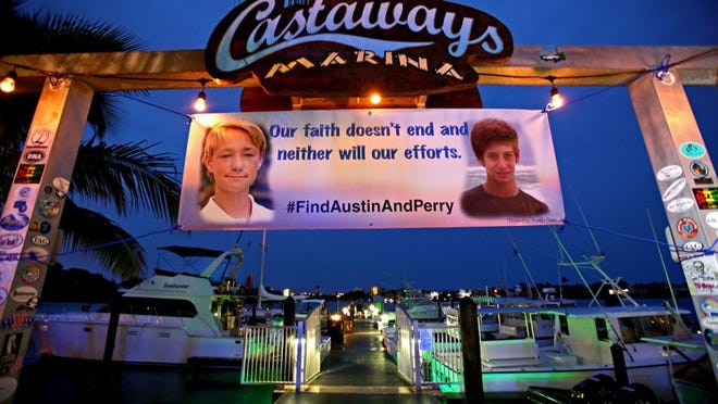 A banner at the Castaways Marina shows pictures of Austin Stephanos and Perry Cohen. After 8 days of searching the ocean, the U.S. Coast Guard ended their search for the boys. (Richard Graulich / The Palm Beach Post)