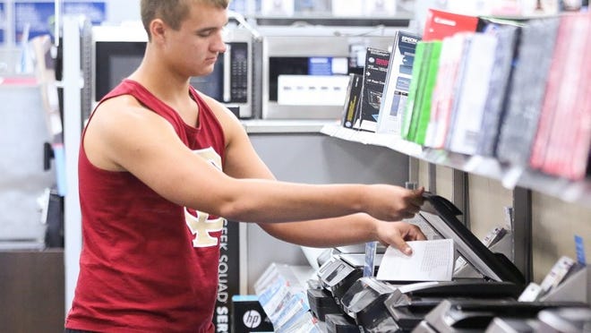 Suncoast High School student Tyler Scott, 17, browses through printers inside the Palm Beach Gardens Best Buy in hopes of purchasing one for school, July 31, 2015. (Damon Higgins / The Palm Beach Post)