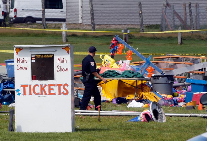 Investigators inspect the site of a circus tent that collapsed Monday during a show by the Sarasota-based Walker Brothers International Circus at the Lancaster Fair grounds in Lancaster, N.H.
