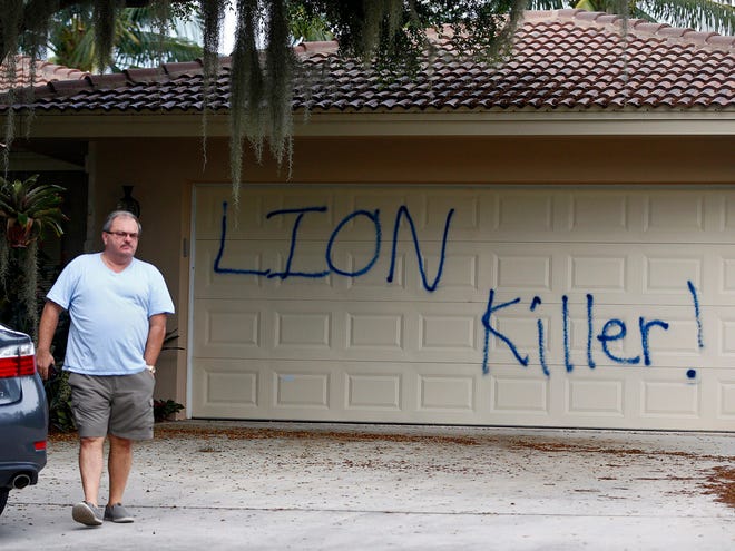 Private Investigator for the Palmer family, Walter Zalisko, of Global Investigative group in Fort Myers, walks out of the Marco Island home of dentist Walter J. Palmer on Tuesday. Zalisko said no vandalism was found inside.