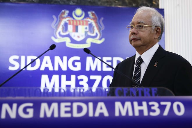 Malaysian Prime Minister Najib Razak, center, arrives for a special press conference announcing the findings for the ill fated flight MH370 in Kuala Lumpur, Malaysia on Thursday, Aug. 6, 2015. Experts have confirmed that the debris found on Reunion Island last week was that of Malaysian Airlines flight 370 that went missing last year, Malaysia's prime minister said Wednesday. THE ASSOCIATED PRESS