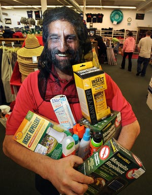Henry Kanner, manager of The Outdoor Store in Natick, with some of his store's mosquito protection products including repellents and personal netting.

Wicked Local Staff Photo / Allan Jung