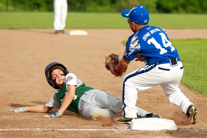Dover's Cam Cunio, left, slides safely into third during Dover's 11-1 loss to Norwalk, Conn., in the Cal Ripken New England 9U Regional Championship at Burnt Hill Park in Hebron, Conn. Thursday night. Chris Palermo/Fosters.com