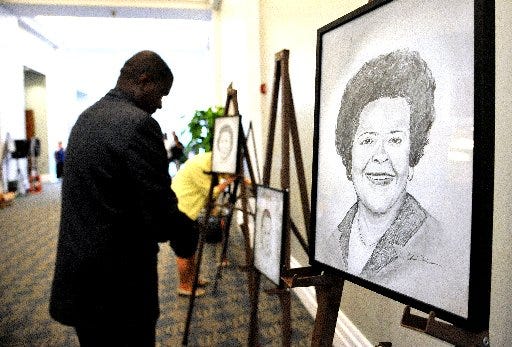 Portraits of the honorees, including the late Mary Littlejohn Singleton (right), lined the hallway to Jacksonville's Main Library auditorium. Fourteen local African-American women were honored at "Celebrating 50 Years, Voting Rights Act 1965-2015" Thursday.