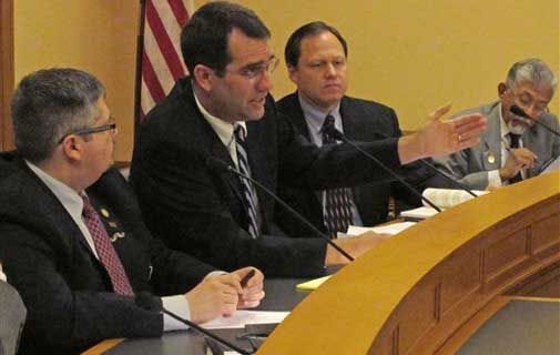 Kansas Attorney General Derek Schmidt, second from the left, is pictured in this file photo.