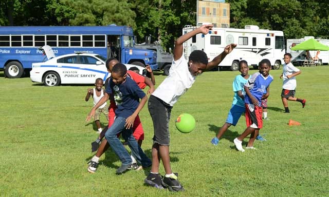 Children play dodgeball with members of the Kinston-Lenoir County Parks and Recreation department Tuesday at National Night Out at Teacher’s Memorial playground and the Martin C. Freeman Center.
