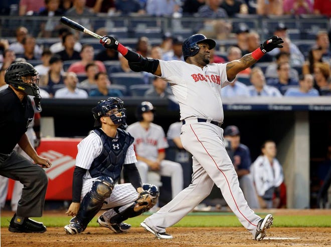 Boston Red Sox's David Ortiz hits a solo home run off New York Yankees starting pitcher Luis Severino as Yankees catcher John Ryan Murphy, middle, watches during the fourth inning of a baseball game at Yankee Stadium in New York, Wednesday, Aug. 5, 2015.