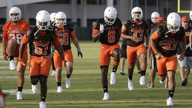 Miami defensive lineman Al-Quadin Muhammad (8) runs drills with his teammates during NCAA college football practice, Thursday, Aug. 6, 2015, in Coral Gables, Fla. The latest effort toward rebuilding, reshaping and rebranding the Hurricanes started more than seven months ago and the next four weeks of training camp will be a culmination of those efforts. (AP Photo/Lynne Sladky)