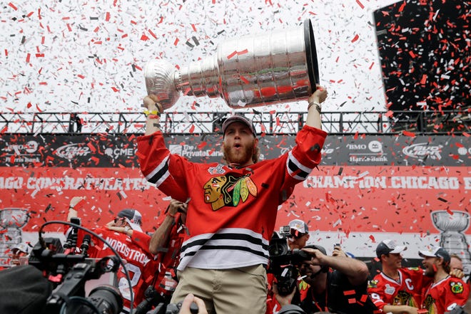 Chicago Blackhawks right wing Patrick Kane holds up the Stanley Cup Trophy during a rally at Soldier Field for the NHL hockey Stanley Cup champions June 18 in Chicago. THE ASSOCIATED PRESS