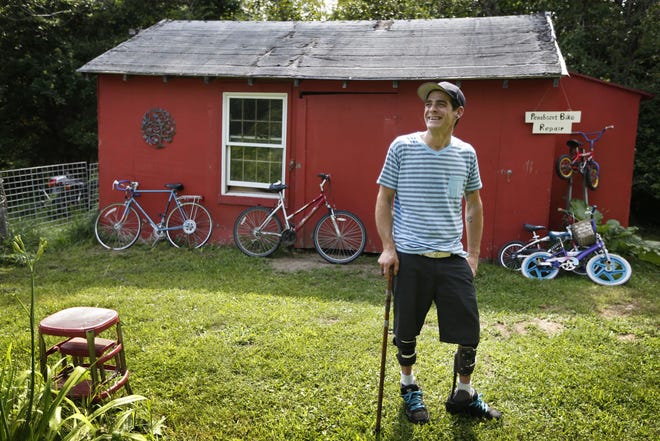 Ryan Kinsella poses outside his bicycle repair business in Penobscot, Maine on July 30. Kinsella broke his back in a rock climbing accident in 2002. The accident left him with partially paralyzed legs. He is recovering from a long battle with hepatitis C., which he contracted by sharing IV drug needles. The rise of cheap heroin has brought a rise in hepatitis C. Perhaps nowhere is the problem starker than in Downeast Maine, which has the highest hepatitis C rate in a state with quintuple the national average. AP Photo/Robert F. Bukaty