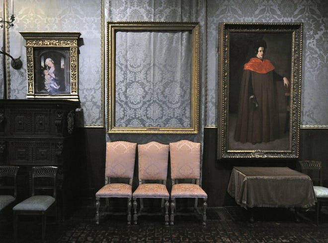 The empty frame, center, from which thieves cut Rembrandt's "Storm on the Sea of Galilee" remains on display at the Isabella Stewart Gardner Museum in Boston. More than a dozen works were stolen from the museum on March 18, 1990. On Thursday, Aug. 6, 2015, the U.S. Attorney's Office released a surveillance video showing an automobile outside the rear entrance and an unauthorized visitor entering the museum 24 hours before the robbery.