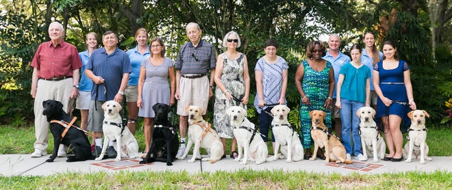 Southeastern Guide Dogs' new graduates with their dogs and trainers: From left, Nick Coates and Hercules; trainer Caitlin O'Brien; Israel Lopez and Gala; trainer Alice Ryskamp; Barbara Reeves and Atlas; John Fleming and Maxine; Jeanne Gates and Tuesday; Anzley Hutto and Kodi; Shameeka Carlisle and Sunshine; trainer Carl Magers; Jessica Woods and Cookie; trainer Marisa Gerlach; Katherine McCoy and Bristol. COURTESY PHOTO