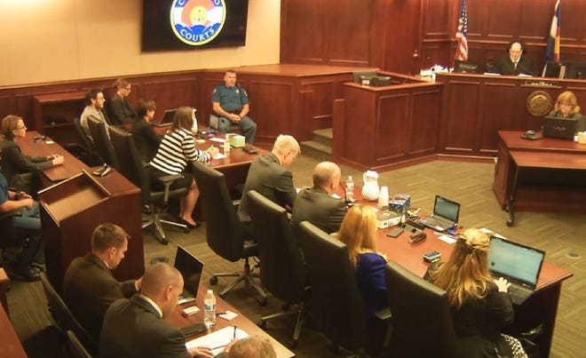 In this image made from Colorado Judicial Department video, James Holmes, top left in tan shirt, watches as Judge Carlos A. Samour, Jr., top right, prepares to read the jury's sentencing verdict in the Colorado theater shooting trial in Centennial, Colo., Friday, Aug. 7, 2015. THE ASSOCIATED PRESS