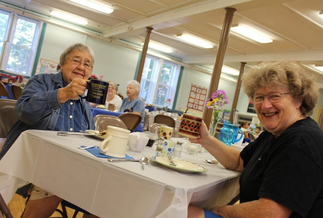 Dottie Bean and Deb Allard reconnect over coffee and blueberry pancakes at Blueberry Fest on Saturday morning. Crystal A. Weyers photo