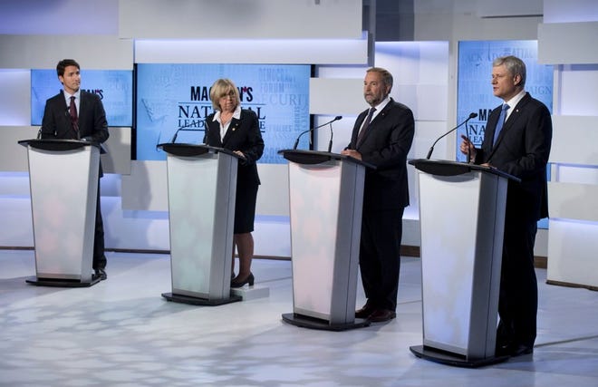LEADERS OF CANADA'S four political parties, Liberal leader Justin Trudeau, from left, Green Party leader Elizabeth May, New Democratic Party leader Thomas Mulcair and Conservative leader Prime Minister Stephen Harper exchange views during the first leaders debate Thursday in Toronto.