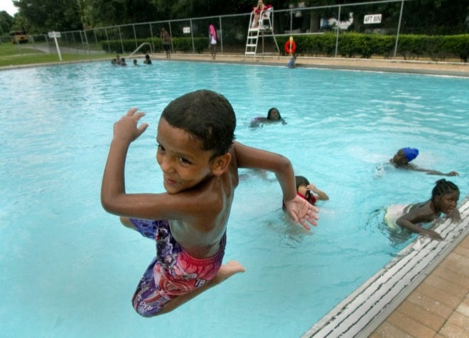 Antonio Cruz, 6, improvises on style as he and a group of children enjoy jumping in and out of the pool during the Children’s Summer Camp at Winter Haven Recreational and Cultural Center on Friday afternoon.
