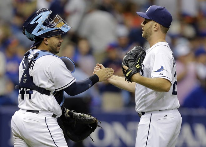 Tampa Bay Rays relief pitcher Brad Boxberger, right, shakes hands with catcher Rene Rivera after closing out the New York Mets during the ninth inning of an interleague baseball game Saturday, Aug. 8, 2015, in St. Petersburg, Fla. The Rays won the game 5-4.