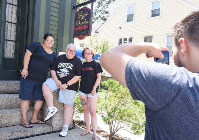 Kelly Scott, from left, of New Bedford, Sue Brault of Fall River and Crystal Oliver of New Bedford stop for a photo after touring the Lizzie Borden Bed & Breakfast/Museum. Jack Foley/Herald News