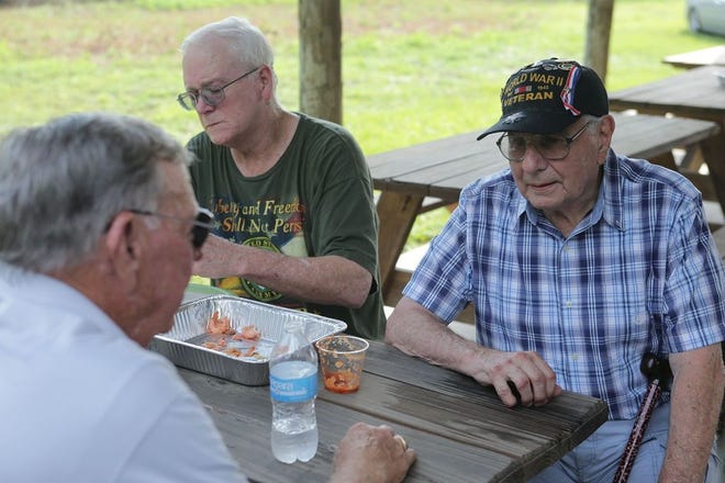 WWII veteran Morgan Donato, right, chats with other veterans during a joint celebration of his upcoming 90th birthday and the birthday of the Purple Heart on Friday, August 7, 2015, in Panama City, Fla. (Heather Leiphart | The News Herald)