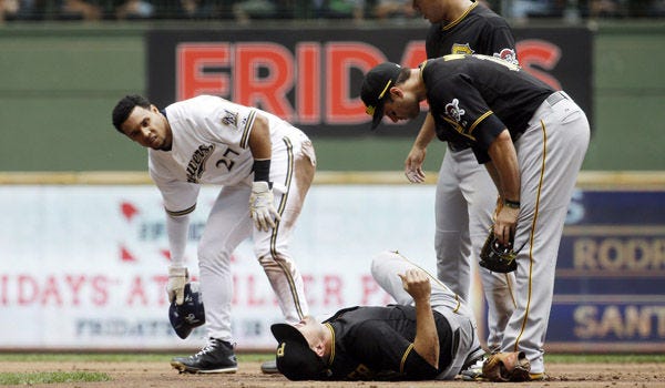 Jordy Mercer (10) collides with Milwaukee Brewers' Carlos Gomez during the second inning of a baseball game Sunday in Milwaukee. Gomez was out on the play and Mercer left the game on a cart.