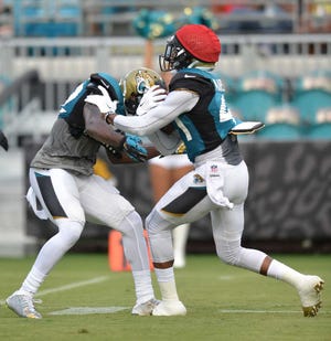 Bruce.Lipsky@jacksonville.com Cornerback Nick Marshall (right) works on special teams during Saturday night's scrimmage at EverBank Field.