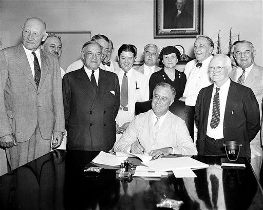 FILE - This Aug. 14, 1935, file photo shows President Franklin D. Roosevelt signing the Social Security Bill in Washington. As Social Security approaches its 80th birthday on Aug. 14, 2015, the federal government's largest benefit program faces serious financial problems that could be fixed with only modest changes, if Congress acts quickly.