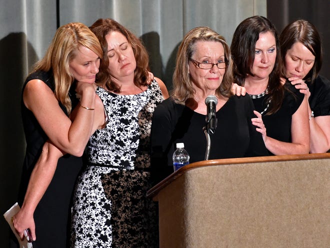 Carol Shore, middle, wife of R. B. “Chips” Shore, is surrounded by their daughters, from left, Elizabeth Shore, Donna Shore Western, Cindy Shore and Debra Shore Quinlan, during the memorial service for the late Manatee County clerk of the Circuit Court at the Bradenton Municipal Auditorium Saturday.
