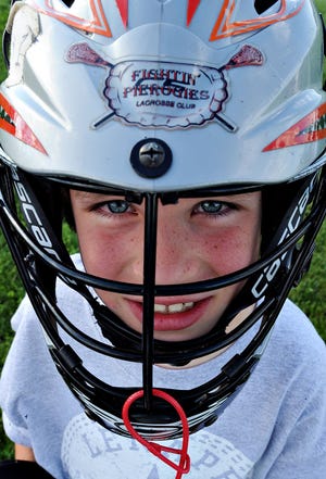 Lech Szambelak, 7, of the Fightin' Pierogies Lacrosse Club has his game face on during the second annual Lenape Lacrosse clinic at Turk Park in Doylestown Township.