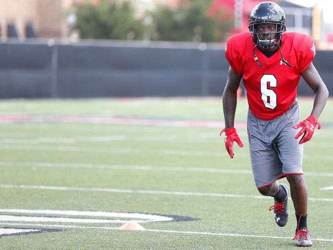 Junior wide receiver Devin Lauderdale warms up during practice on campus in Lubbock on Monday.